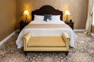 a bedroom with a large bed and a chair at The Mount Vernon Grand Hotel in Mount Vernon +21 photos