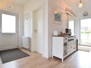 a room with a kitchen with a stove and a window at Sauve holiday home in Zierow with fenced garden in Zierow