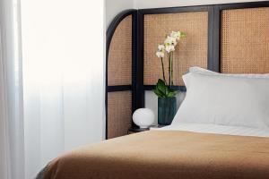 A bed or beds in a room at Magnolia Boutique Rooms