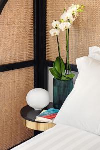 A bed or beds in a room at Magnolia Boutique Rooms