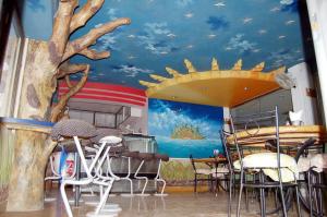 a dining room with a mural of a kitchen at Hotel Kanak Sagar in Ajmer