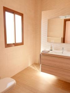 a bathroom with a sink and a mirror at Casa Arts guest rooms in Alcaucín