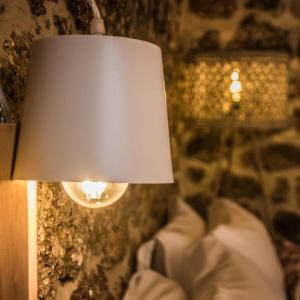 a lamp that is sitting next to some pillows at Anotopos in Ano Trikala