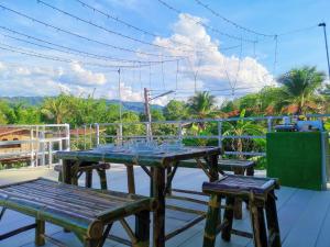 a table and chairs on the roof of a house at Mint Organic Farm Stay, Wangchin,Phrae in Ban Mae Katom