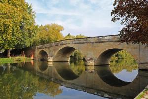 a bridge over a body of water with trees at Shillingford Bridge Hotel in Wallingford