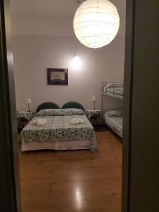 a bedroom with a bed and two bunk beds at Albergo Lungomare in Bonassola