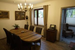 a dining room with a wooden table and chairs at Heckes Ferienwohnung in Schöneiche