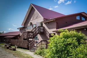 a large house with wooden stairs leading up to it at Bedrock Motel in Mayo Landing