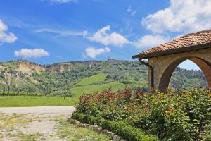 a stone building with a view of a mountain at Agriturismo Podere Marcampo in Volterra