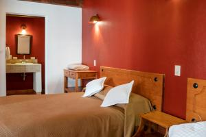 Ein Bett oder Betten in einem Zimmer der Unterkunft Hotel Casa Margarita
