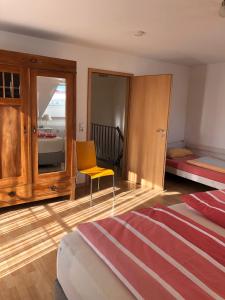 a bedroom with a bed and a yellow chair at Apartment Carmen in Rust