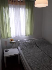 Raj Pegaz في Vrnjačka Banja: غرفة نوم صغيرة بها سرير ونافذة