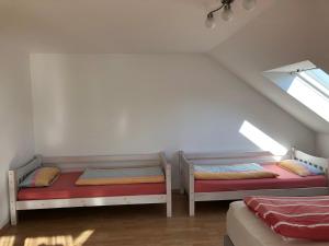 a attic room with two beds and a window at Apartment Carmen in Rust