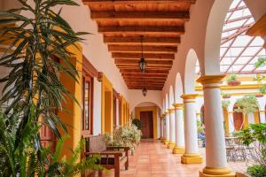 an arcade in a building with yellow and white walls at Hotel Casa Margarita in San Cristóbal de Las Casas