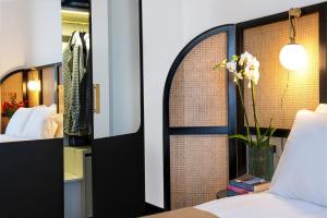 A bed or beds in a room at Magnolia Boutique Rooms