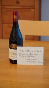 a bottle of wine with a sign next to it at Haus Green 31 in Davos