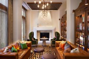 a living room with two couches and a fireplace at The Plaza Hotel Pioneer Park in El Paso