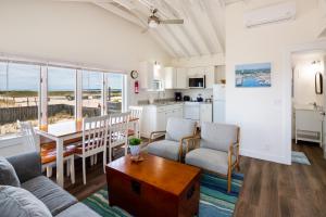 a living room with a couch and a table at Truro Beach Cottages in Truro
