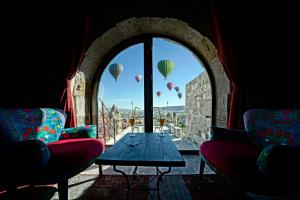 a room with a table and hot air balloons in the sky at Arinna Cappadocia in Göreme