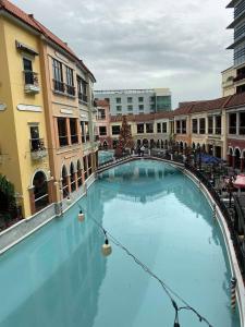 a large swimming pool with a christmas tree in a courtyard at Venice Luxury Studio w/Balcony @McKinley Hill in Manila