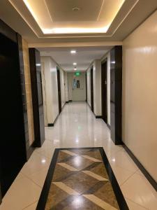 a hallway in a building with a tile floor at Venice Luxury Studio w/Balcony @McKinley Hill in Manila
