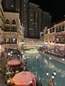 a view of a river in a city at night at Venice Luxury Studio w/Balcony @McKinley Hill in Manila