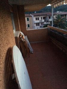 vista su un balcone con tavola da surf in un edificio di La Residenza a Porto Azzurro