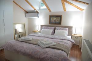 a bedroom with a large bed with two towels on it at Vila Lily in Smederevo +51 photos