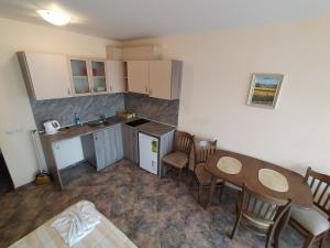 a small kitchen with a table and chairs in a room at Sunny Sands Studios in Burgas +135 photos