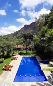 a swimming pool with a mountain in the background at Finca Catalina Hotel Boutique in Tepoztlán