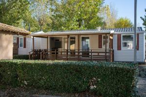 a small house with a porch and a fence at La Carabasse / Mazet 69 in Vias