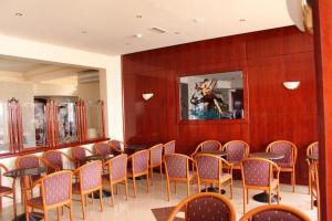 a room with a bunch of chairs and tables at Rodos Star Hotel in Afantou