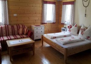 a living room with two beds and a couch at Hof Zaunfranzl in Stubenberg