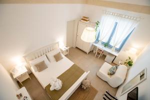 a small bedroom with a bed and a living room at La Casa Della Zia in San Pancrazio Salentino