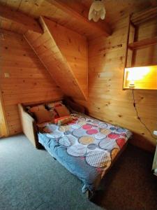 a bedroom with a bed in a log cabin at Góralska Chata in Kościelisko