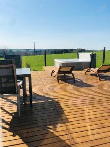 a group of chairs and tables on a wooden deck at Lodge spa in Petit-Réderching