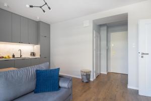 a living room with a couch and a kitchen at Portova Apartament in Gdynia