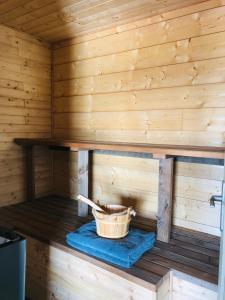 a inside of a wooden sauna with a bucket at Lodge spa in Petit-Réderching