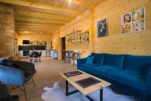 a living room with a blue couch and a table at Holiday home Natura in Slunj