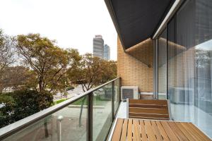 a balcony of a building with glass doors and stairs at Comtal homey apartments in Barcelona