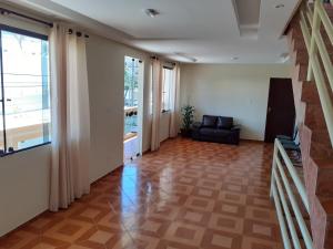 a living room with a couch and a window at Hotel Litoral in Aracaju