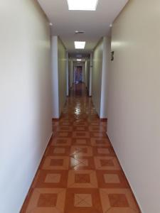 an empty corridor in an office building with a hallway at Hotel Litoral in Aracaju