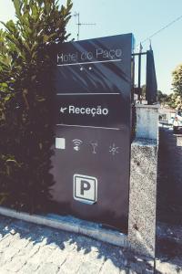 a sign for a hotel go pasco on a street at Hotel do Paço in Guimarães