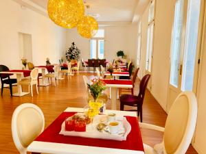 ein Restaurant mit Tischen und Stühlen mit Essen darauf in der Unterkunft Palazzo Otello 1847 Wellness & Spa in Vicenza
