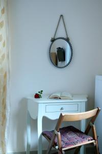 a table with a mirror and a chair at Apartments Avra in Lefkada