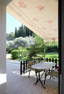 a patio area with chairs, tables and umbrellas at Apartments Avra in Lefkada