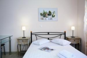 a hotel room with a bed and a lamp at Apartments Avra in Lefkada