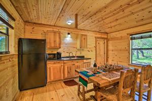 a kitchen with a dining table and a refrigerator at Rustic-Chic Country Cabin - 10 Mi to Main Street! in Fredericksburg