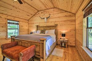 a bedroom with a bed in a log cabin at Rustic-Chic Country Cabin - 10 Mi to Main Street! in Fredericksburg