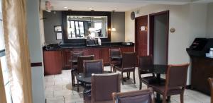 a dining room with tables and chairs and a bar at Inn at Mulberry Grove in Port Wentworth